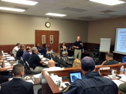 DA Parks White (lower left) looks on as GBI Agent Mike Ayers talks about interviewing suspects.