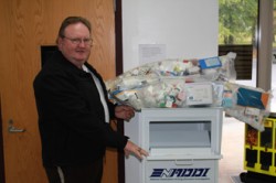 Sheriff Stevie Thomas stands by bags of prescription drugs turned in by citizens on National Drug Take Back Day.