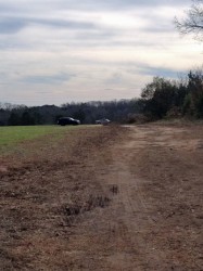 Authorities search field Friday where hunter was shot.