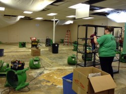 Habitat crews sort through items while blowers run to dry out the main showroom floor