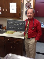 Dr. Hitchcock poses with plaque presented to him Tuesday by his staff 