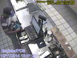 Store surveillance video shows black male suspect take money from cash register