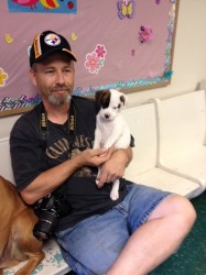 David Houser holds the stolen puppy he pre-adopted after it was returned to the shelter Thursday
