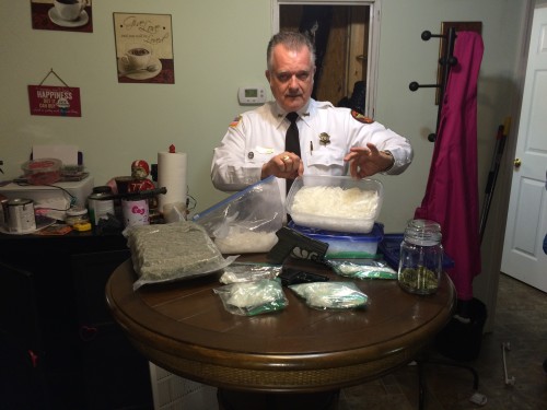 Sheriff Randy Shirley holds up the drugs seized in a bust on Hayes Road last week.